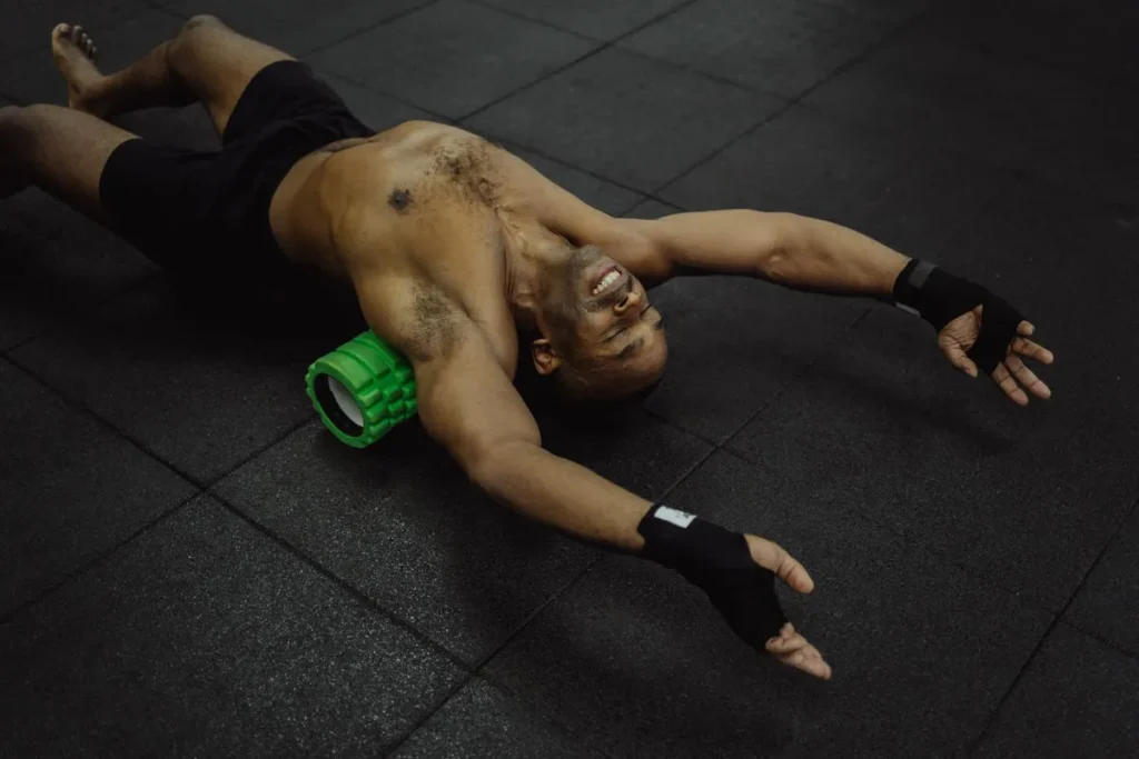 Athlete foam rolling quadriceps after workout