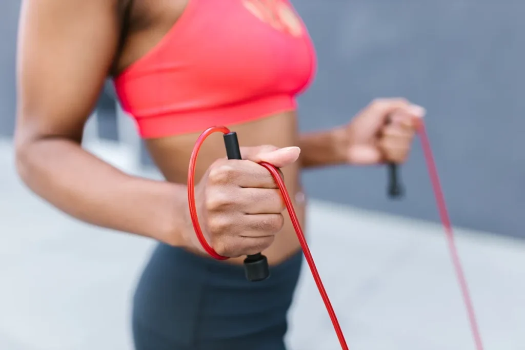 Person performing jump rope cardio workout at home