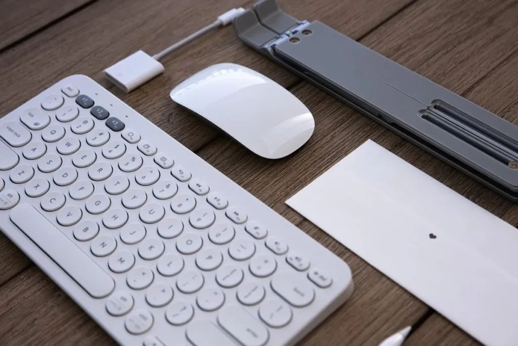 Minimalist wireless desk setup with mouse charging station and laptop